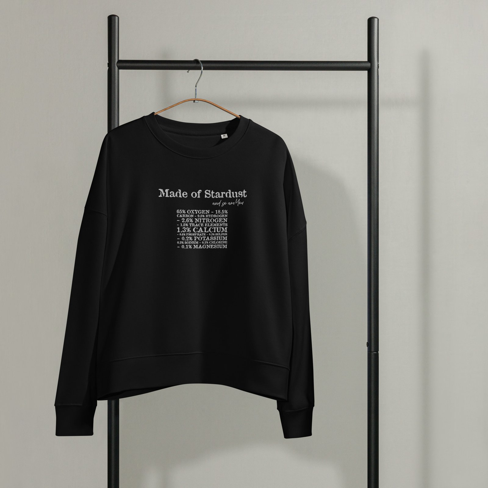 womens-organic-crew-neck-sweatshirt-black-front-690d2cd352b2e.jpg Black organic cotton crewneck sweatshirt with 'Made of Stardust' embroidery
